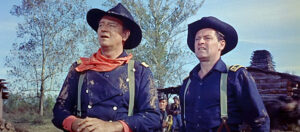 John-Wayne-as-Col.-John-Marlowe-and-William-Holden-as-Maj.-Henry-Kendall-watching-Southern-troops-advance-in-The-Horse-Soldiers-1959.jpg